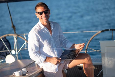 Photo for Man on a boat. Charismatic man in white clothes on a yacht - Royalty Free Image