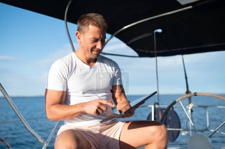 Téléchargez les photos : Un homme sur un bateau. Homme charismatique en vêtements blancs sur un yacht - en image libre de droit
