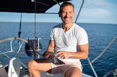 Photo for Man on a boat. Charismatic man in white clothes on a yacht - Royalty Free Image