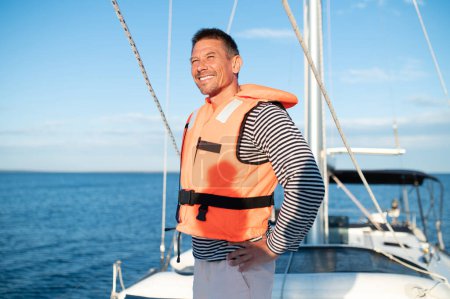 Photo for On a yacht. Mature man in a life jacket on a yach feeling good - Royalty Free Image