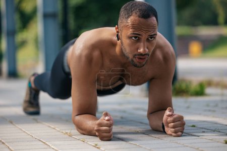 Photo for PLank. Young well-built african american man standing in plank - Royalty Free Image