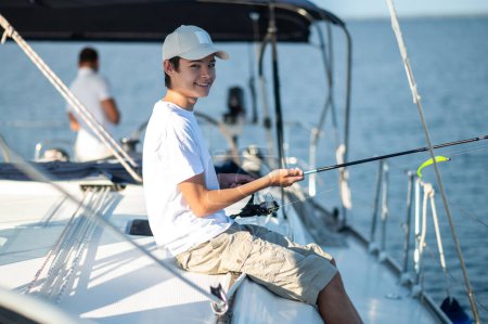 Photo for On a yacht. Smiling teen in a cap on a yacht - Royalty Free Image
