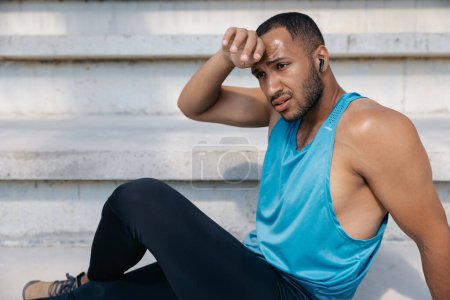 Photo for Resting. Dark-skinned sportsman resting after workout - Royalty Free Image