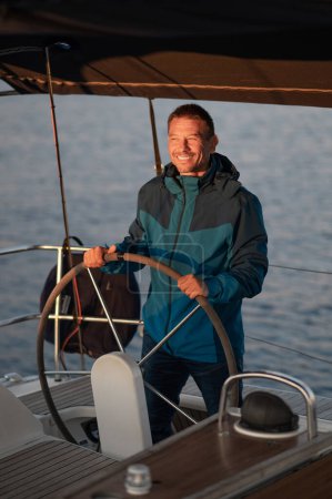 Photo for Man on a yacht. Mature man standing near the steering whell on the yacht - Royalty Free Image
