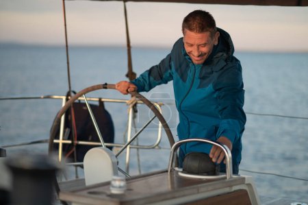 Photo for Man on a yacht. Mature man standing near the steering whell on the yacht - Royalty Free Image