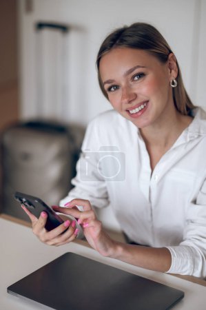 Photo for At work. Cute young business woman in a white blouse with the phone in hand - Royalty Free Image