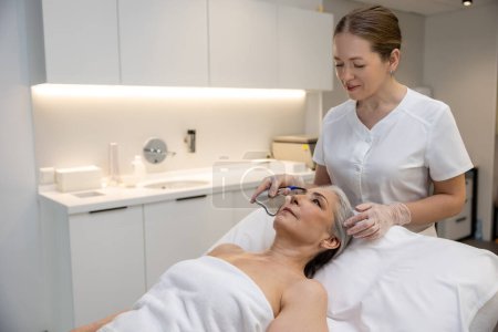 Photo for Beauty care. Mature woman having beauty procedure at cosmetological clinic - Royalty Free Image