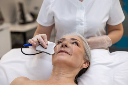 Photo for Mesotherapy. Mature gray-haired woman having a mesotherapy treatment - Royalty Free Image