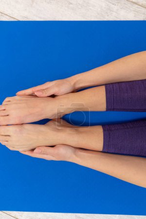 Photo for Yoga. Close up picture of woman doing yoga and holding feet - Royalty Free Image