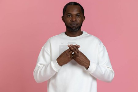 Photo for Deaf mute black man wearing white sweatshirt gesturing sign language isolated over pink background. - Royalty Free Image
