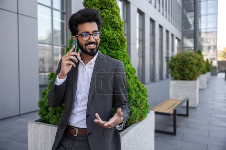 Photo for Bearded smiling handsome hindu businessman with a phone in hands - Royalty Free Image