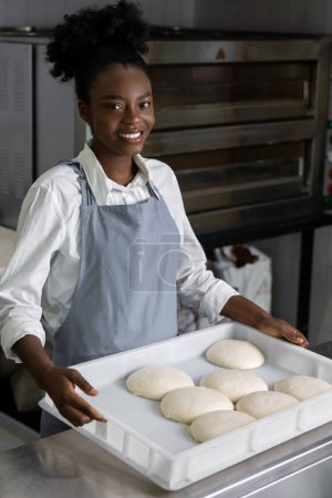 Photo for African american woman in pizzeria preparing for baking pizza - Royalty Free Image