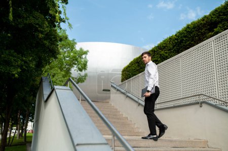 Photo for Urban life. Male businessman on the steps in the city center - Royalty Free Image