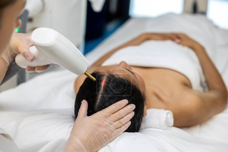 Photo for Laser procedures. Patient in a beauty clinic having laser procedures for hair - Royalty Free Image