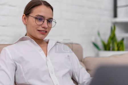 Photo for Woman freelancer in glasses working online in home interior. - Royalty Free Image
