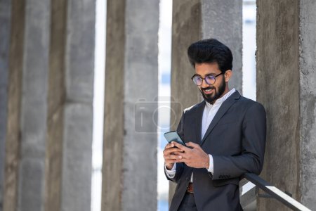 Photo for Good-looking young hindu businessman with a phone in hands - Royalty Free Image