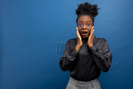 Dark-skinned young woman looking astonished