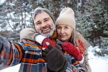 Photo for Happy couple. Mature couple looking happy and making selfie - Royalty Free Image
