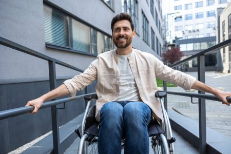 Photo for Good mood. Disabled man on a wheelchair looking positive and smiling - Royalty Free Image