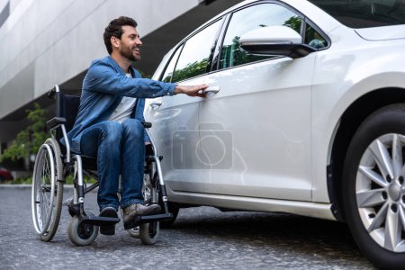 Photo for Disabled man at the car. Bearded disabled man in a wheelchair near the car - Royalty Free Image