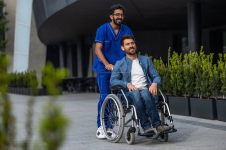Photo for Nurse and patient. Brunette man in doctors overall carrying a wheelchair with a patient - Royalty Free Image
