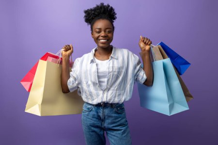 Photo for After shopping. Smiling pretty dark-skinned girl with gift bags looking excited - Royalty Free Image