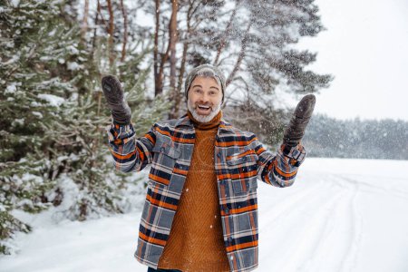 Photo for Feeling excited. Man in checkered jacket feeling good while spending time in a winter forest - Royalty Free Image