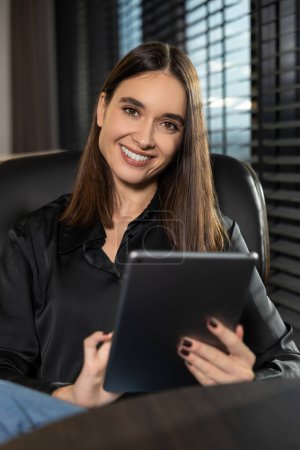 Photo for Young professional. Cute young business woman with a tablet in hands - Royalty Free Image