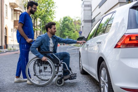 Photo for Car for disabled man. Man in a wheelchair opening a car door - Royalty Free Image