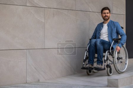 Photo for Confident. Young bearded man riding a wheelchair looking confident - Royalty Free Image