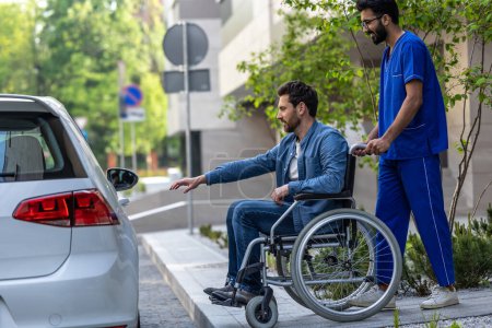 Photo for Vehicle for disabled man. . Man on a wheelchair getting into a car - Royalty Free Image