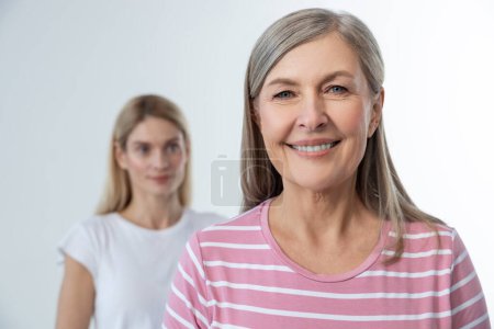 Photo for Smiling women. Two women on a studio photo smiling and looking confident - Royalty Free Image