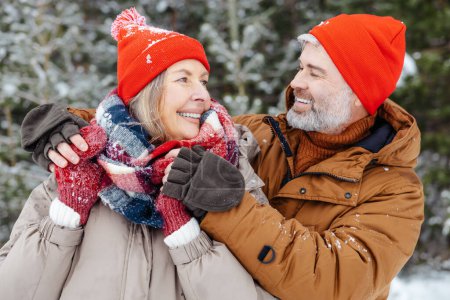 Photo for Winter romance. Mature couple looking close and romantic while spending time in a winter park - Royalty Free Image
