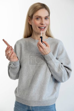 Photo for Make up. Young blonde woman holding lipstick in hands - Royalty Free Image