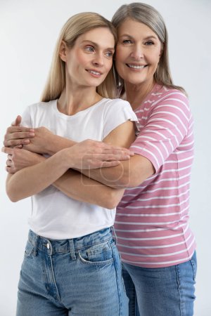 Photo for Caring mother. Mom hugging her daughter and smiling happily - Royalty Free Image