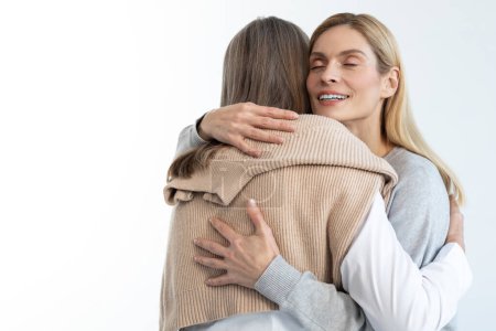 Photo for Happy daughter. Blonde woman hugging her mom and looking happy - Royalty Free Image
