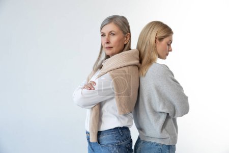Photo for Misunderstanding. Mom and daughter standing back to back with serious look - Royalty Free Image