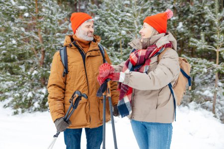 Photo for Good time. A mature couple spending good time together in a winter forest - Royalty Free Image