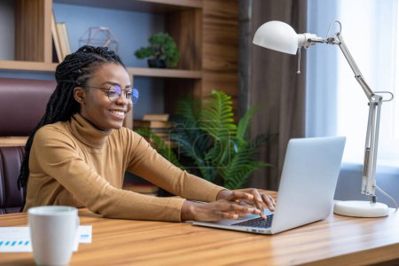 Photo for Confident professional in glasses with dreadlocks works online from home office - Royalty Free Image