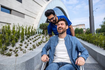 Photo for Disability. Handsome man sitting in a wheelchair while having a walk with a male nurse - Royalty Free Image