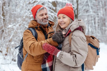 Photo for Leisure. Happy mature couple spending time in a snowy forest - Royalty Free Image
