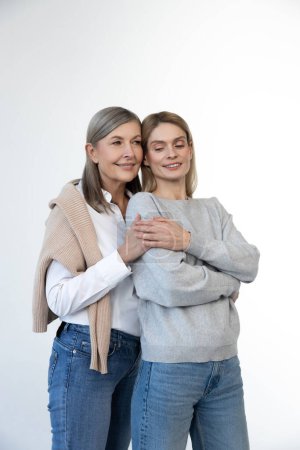 Photo for Femininity. Blonde woman and her mom looking contented and confident - Royalty Free Image
