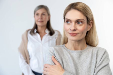 Photo for Femininity. Blonde woman and her mom looking contented and confident - Royalty Free Image