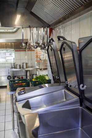 Photo for Empty industrial dishwasher in restaurant kitchen washing dishes - Royalty Free Image