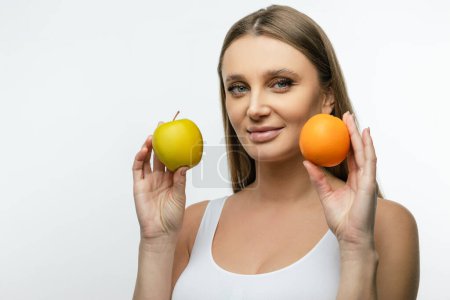 Photo for Healthy diet. Waist up of a young woman with fruits in hands - Royalty Free Image