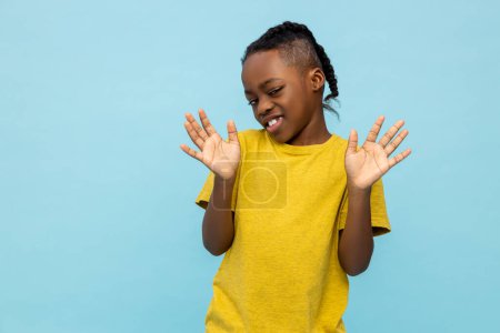 Photo for Displeased African American little boy sees something unpleasant isolated over blue background - Royalty Free Image