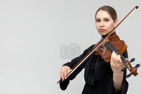 Photo for Woman professional violist playing musical instrument isolated over white background, copy space - Royalty Free Image