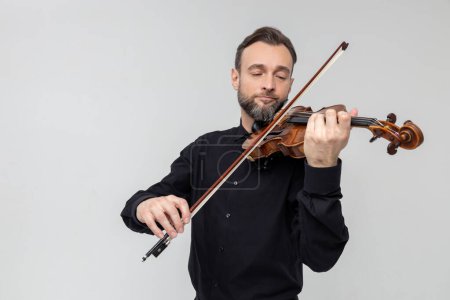 Photo for Attractive bearded violist man playing instrument isolated over white background - Royalty Free Image