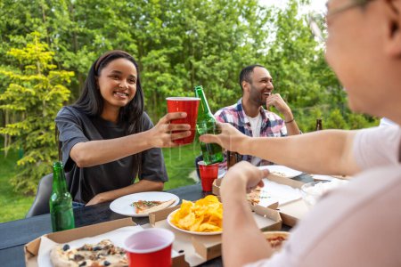 Photo for Overjoyed friends meeting for picnic together having fun with alcohol outdoor - Royalty Free Image