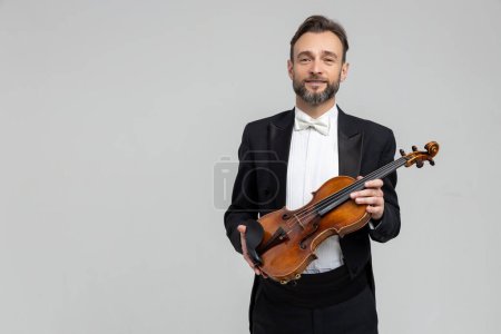 Photo for Bearded musician performed violin at classical music concert isolated over light gray background, copy space - Royalty Free Image
